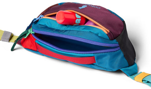 Opened bright-colored fanny pack with visible chapstick.