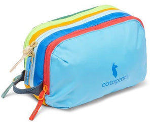 Small, rectangular, multi-colored pouch with blue, red, yellow and green horizontal stripes and the text "cotopaxi" with an alpaca icon on its side.