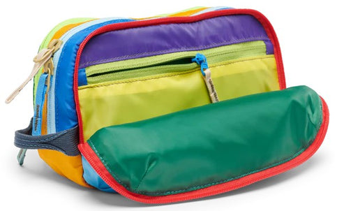 Open, multicolored striped travel kit with red trim, yellow interior, zippered pockets and handle.