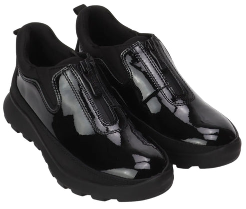 A pair of black, glossy, patent leather slip-on shoes with a central vertical zipper and chunky, black lug soles, isolated on a white background.