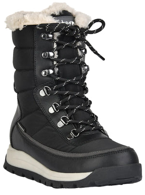A black, mid-calf winter boot with a cream-colored faux fur lining at the top, a quilted shaft, silver eyelets with a black and white patterned lace-up closure, and a thick cream and black lugged rubber sole.