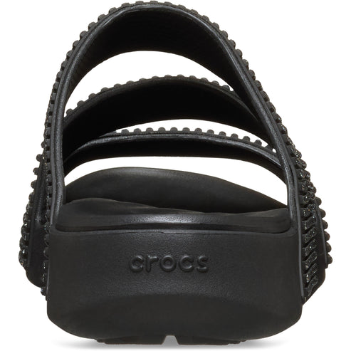 Black sandal with three studded straps and the word "crocs" on the heel.