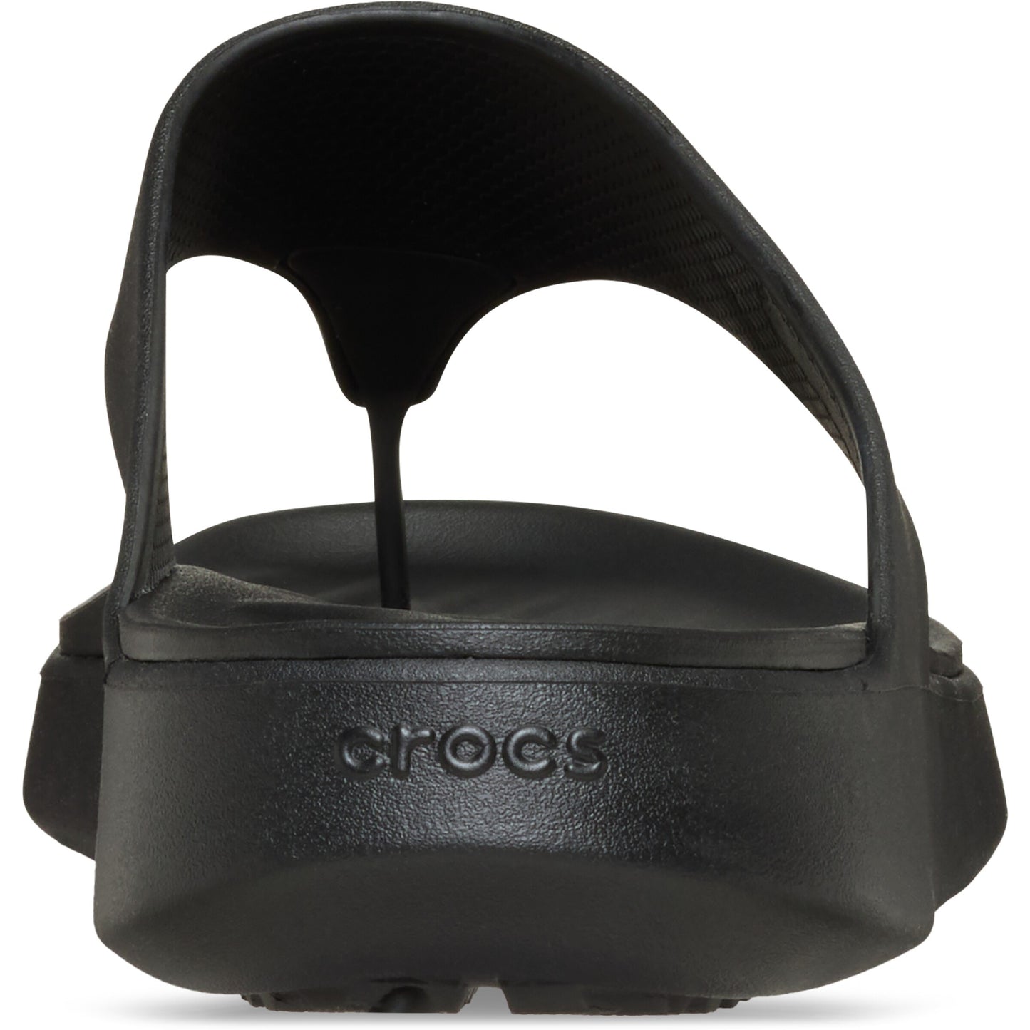 Close-up back view of a black flip-flop sandal, featuring a rounded, elevated sole with embossed 'crocs' text.