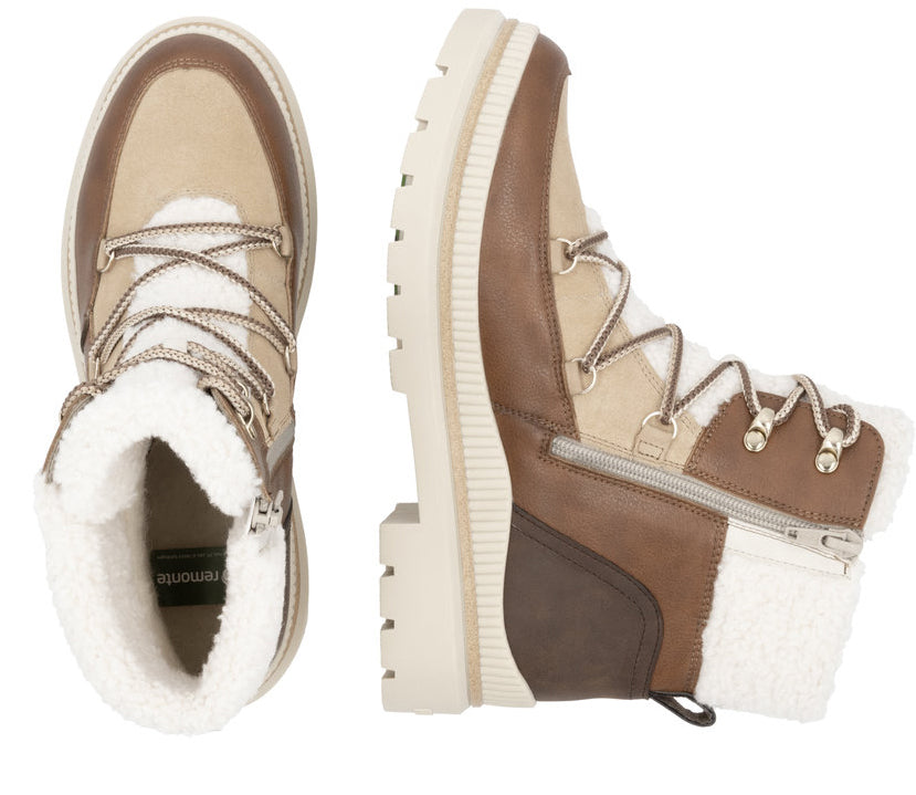 Pair of brown and beige, shearling-lined lace-up boots.