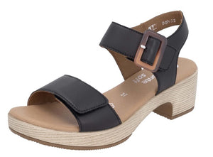 Black sandal with block heel and velcro straps.
