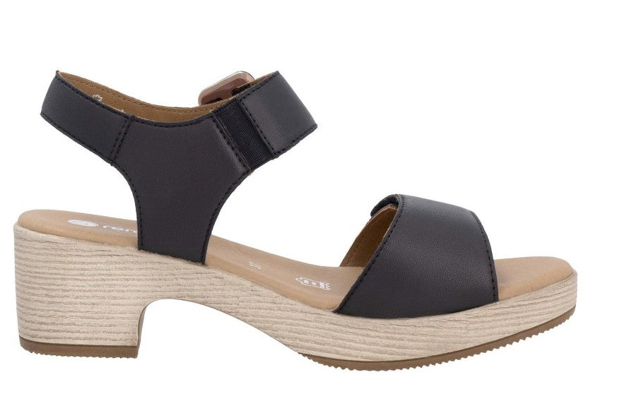 Black sandal with a block heel and velcro straps.