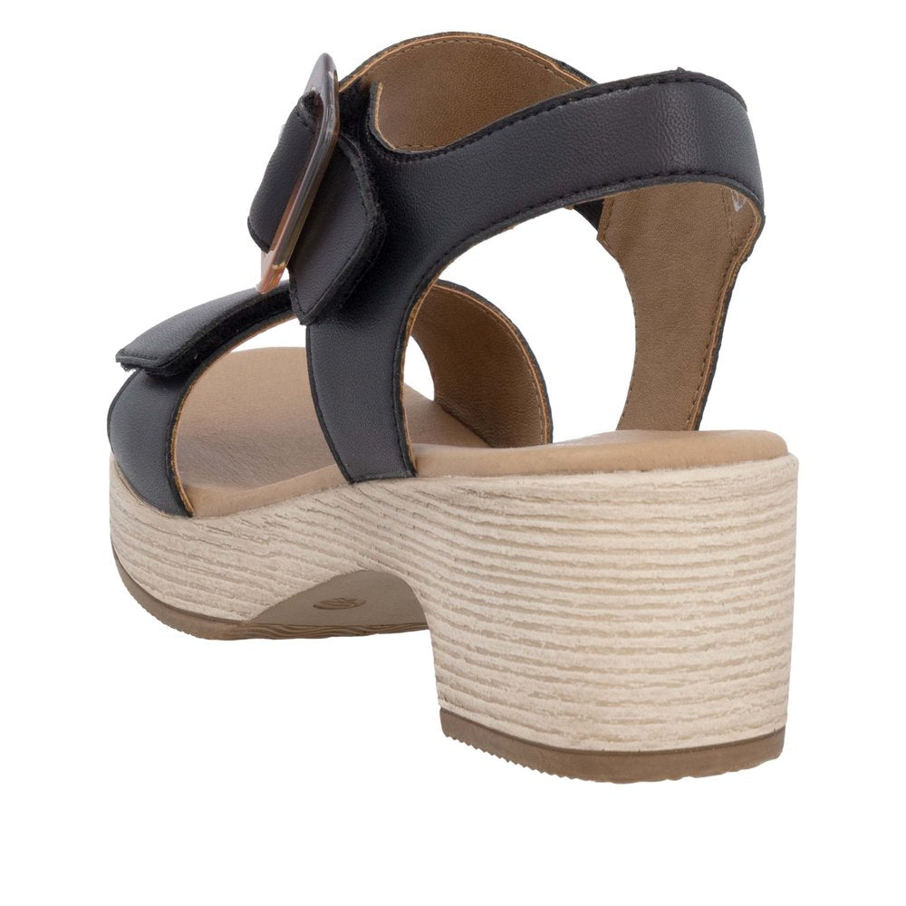 Black sandal featuring a rounded heel and velcro straps.
