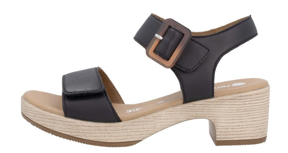 Black sandal with velcro straps and block heel.