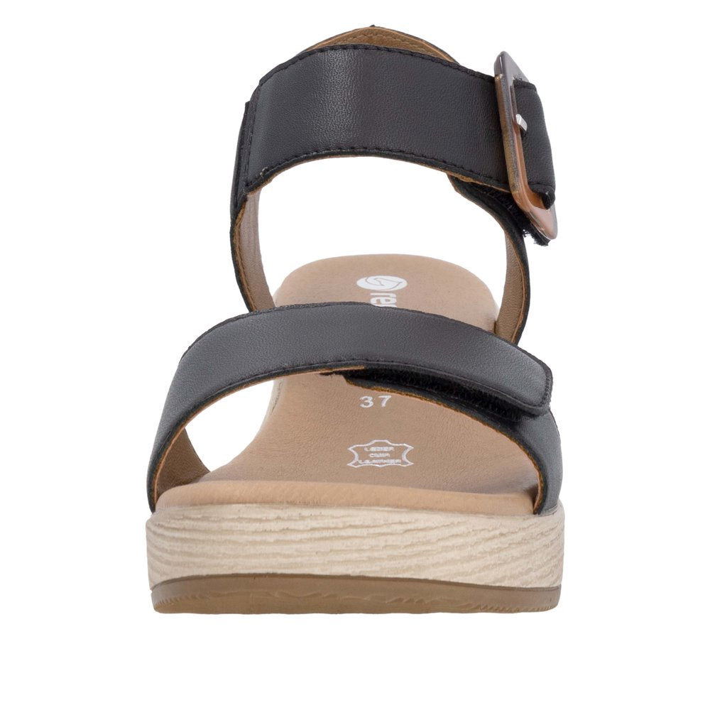 A black, open-toed sandal with two straps, a buckle, and a platform sole.