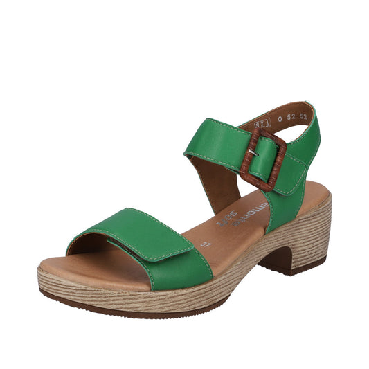 A green sandal with an ankle strap and a wooden buckle.