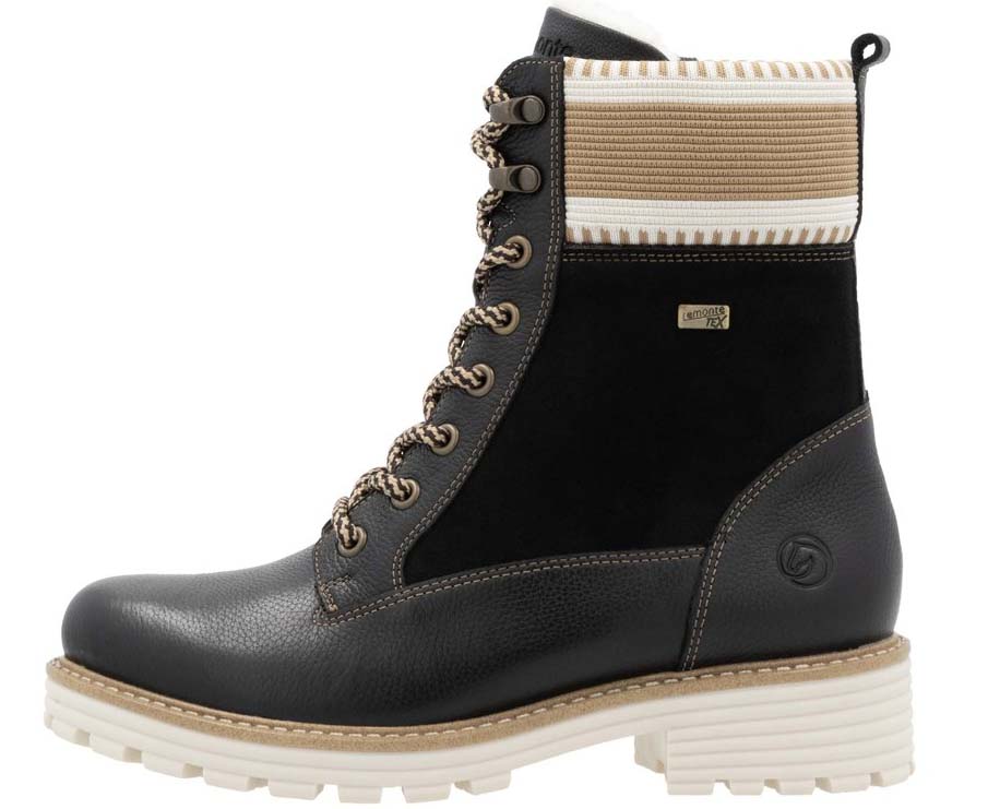 Black lace-up boot with a tan and white band at the top and a thick white tread.