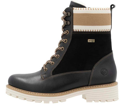 Black lace-up boot with a tan and white band at the top and a thick white tread.