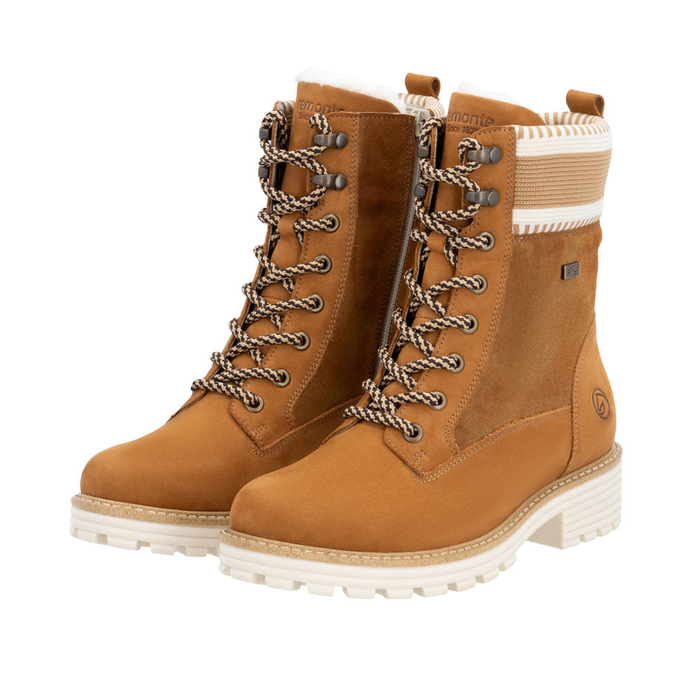 Pair of light brown combat boots with lug soles and knit trim.