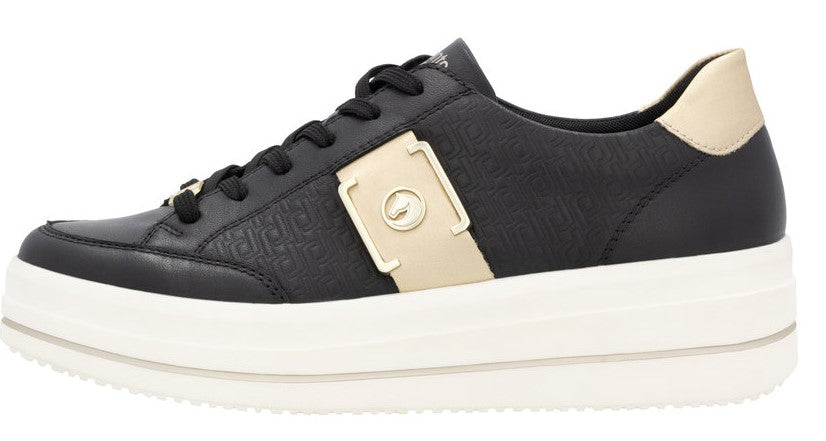 Low-top black sneaker with thick white sole and gold accents.