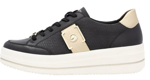 Low-top black sneaker with thick white sole and gold accents.