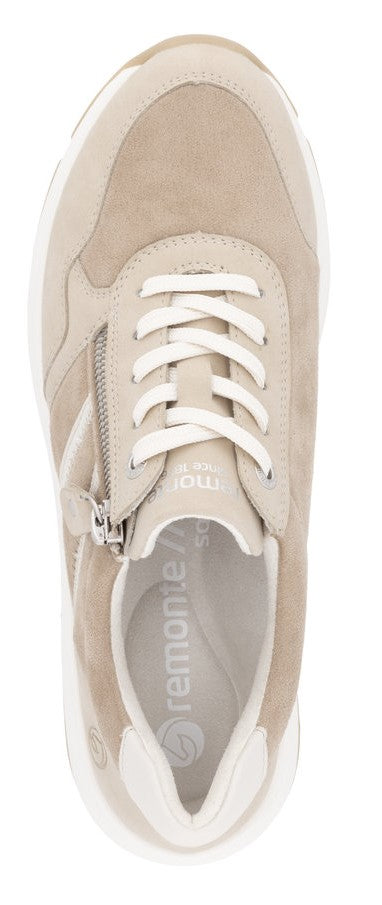 A top-down view of a beige sneaker with white laces and a zipper.