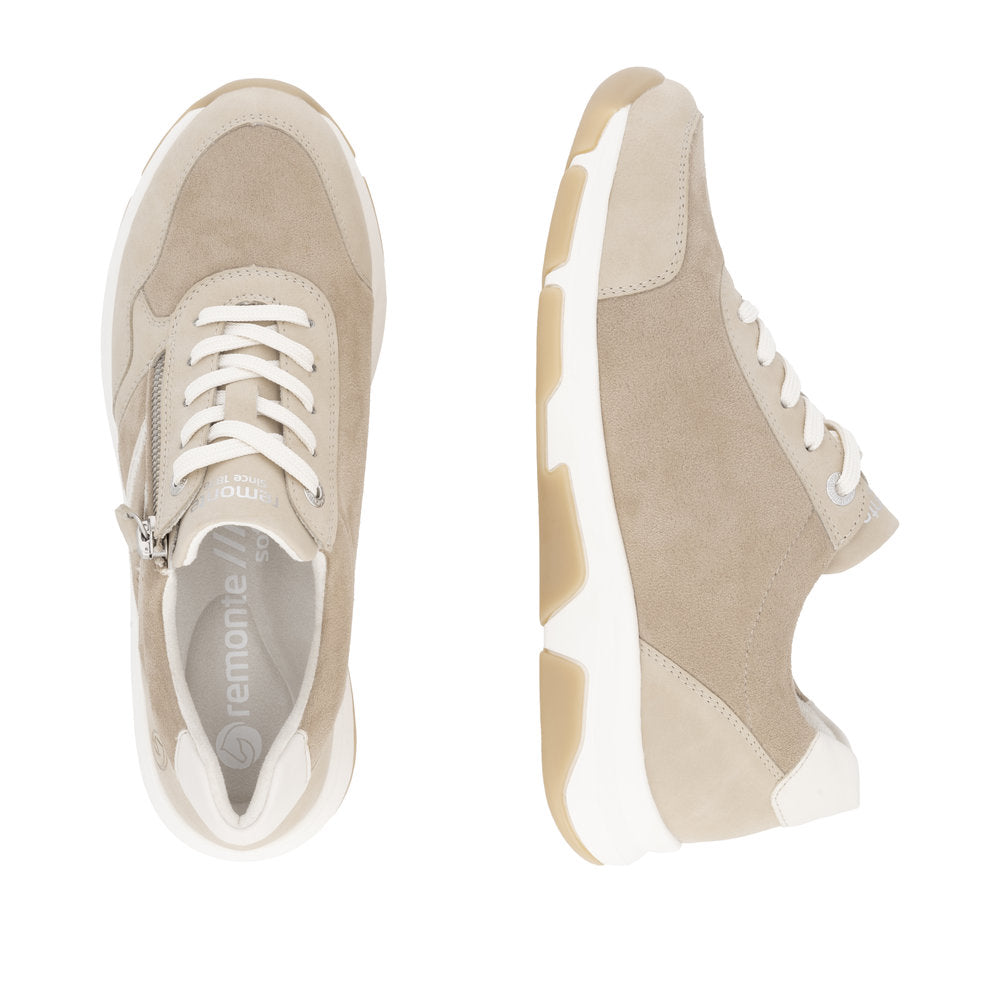 Beige sneakers with white laces and a zipper closure on the side, visible logo "remonte" on the insole.