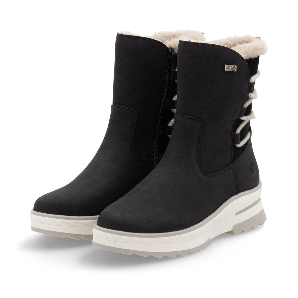 A pair of black mid-calf boots with white faux fur trim and lace-up detail.