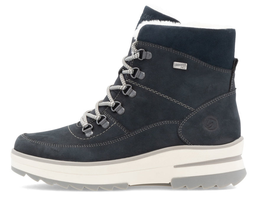 Side view of a navy blue lace-up winter boot with white faux fur lining and a platform sole.