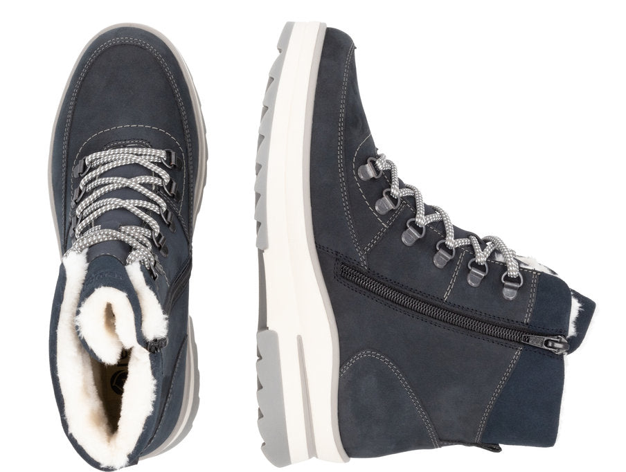 Two views of an ankle-high boot, one from the top and one from the side. The boot is navy blue with light gray laces and a light gray and white sole. The inside of the boot is lined with white fur.