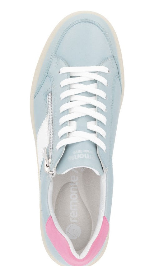 Top-down view of light blue leather sneakers with white laces and a white and silver emblem on the side, complemented by a pink accent at the heel.