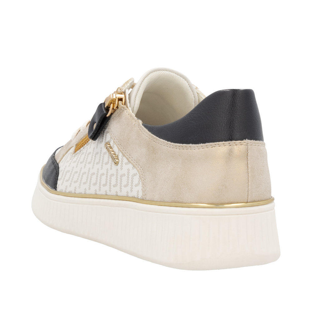 Low top sneaker with white patterned side and gold trim.