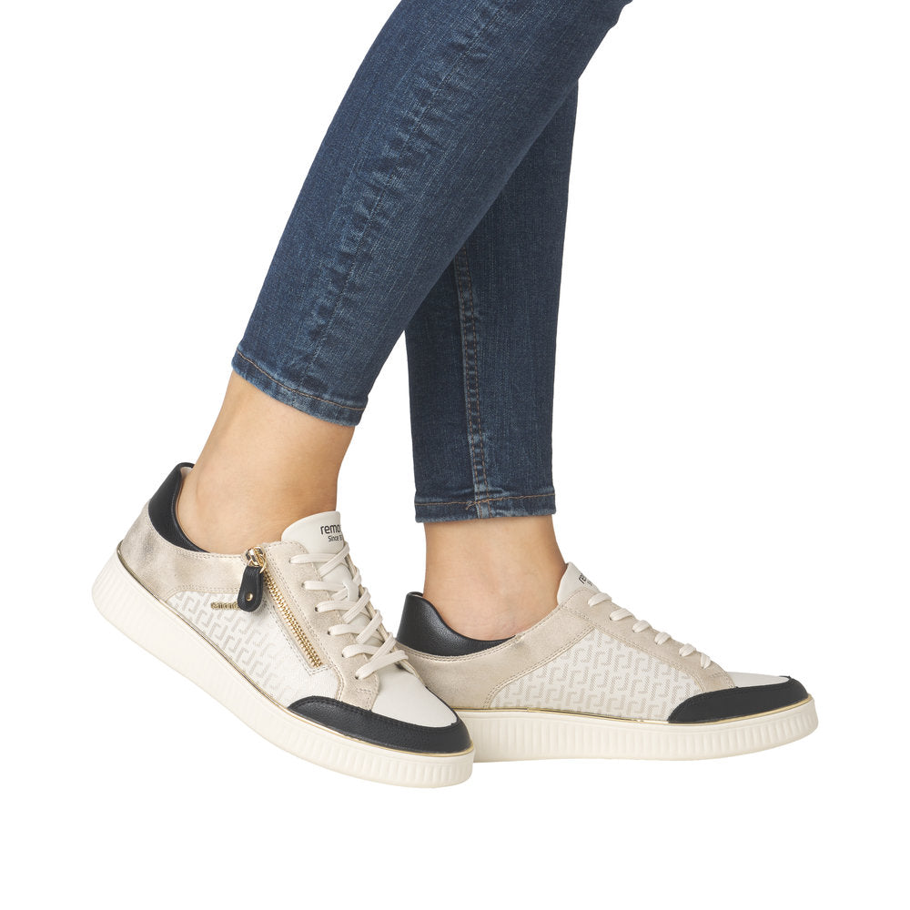 A pair of low-rise sneakers featuring black toe caps and heel counters, lace-up closure with an added zipper, and white soles.