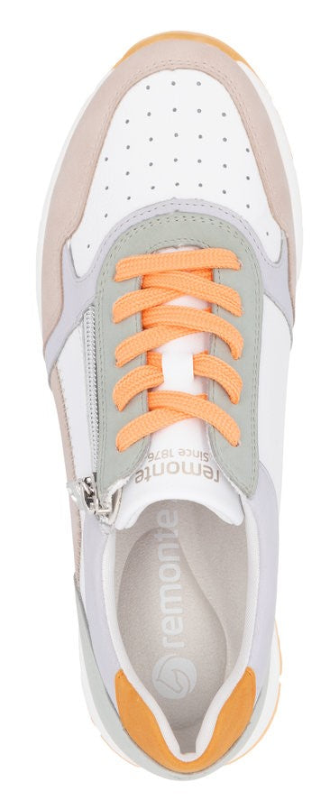 A top-down view of an athletic shoe with peach-colored laces, a light gray and white tongue, and a white upper with ventilation holes.