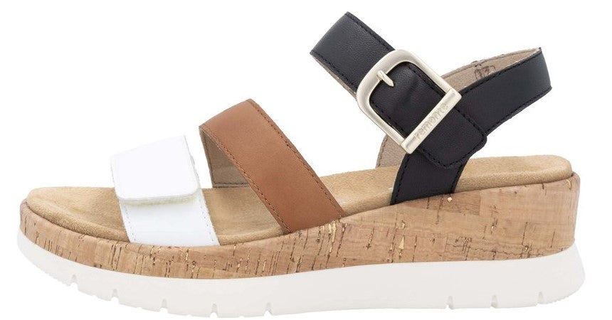 Cork platform sandal with white, tan and black straps and a buckle.
