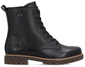 Black leather combat boot with laces and brown sole.