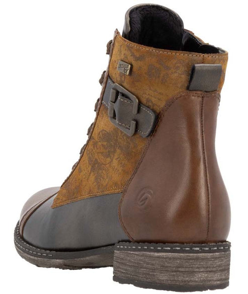 Ankle boot featuring a lace-up front, decorative buckle strap, and patchwork design with brown, tan, and gray panels.