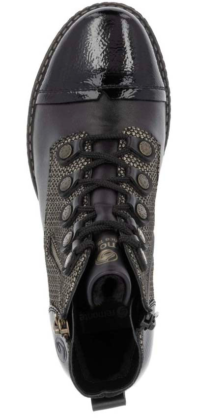 A high-angle shot of a black lace-up boot with a shiny cap toe and a decorative patterned upper.