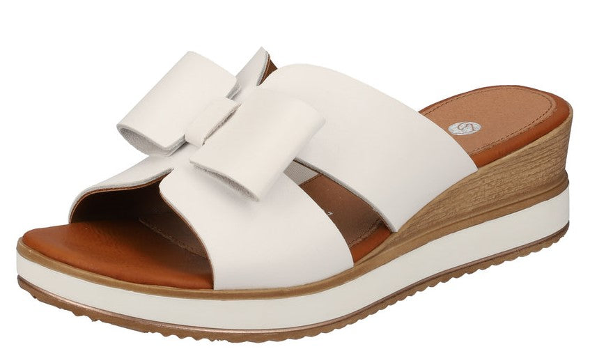 White sandal with bow accent, wedge heel, and platform sole.