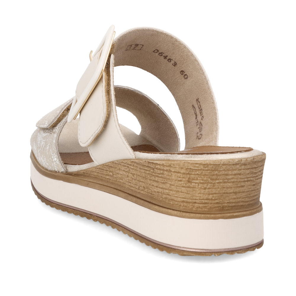 A women's off-white sandal with a platform sole and two decorative flower-shaped velcro straps.