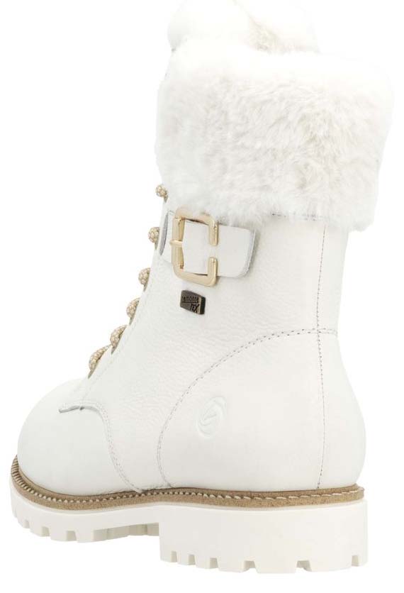 White leather boot with fuzzy white trim, buckle, and lug sole.