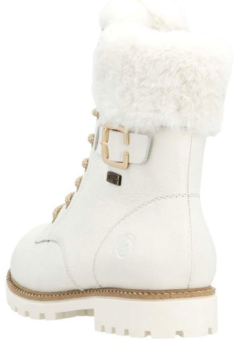 White leather boot with fuzzy white trim, buckle, and lug sole.