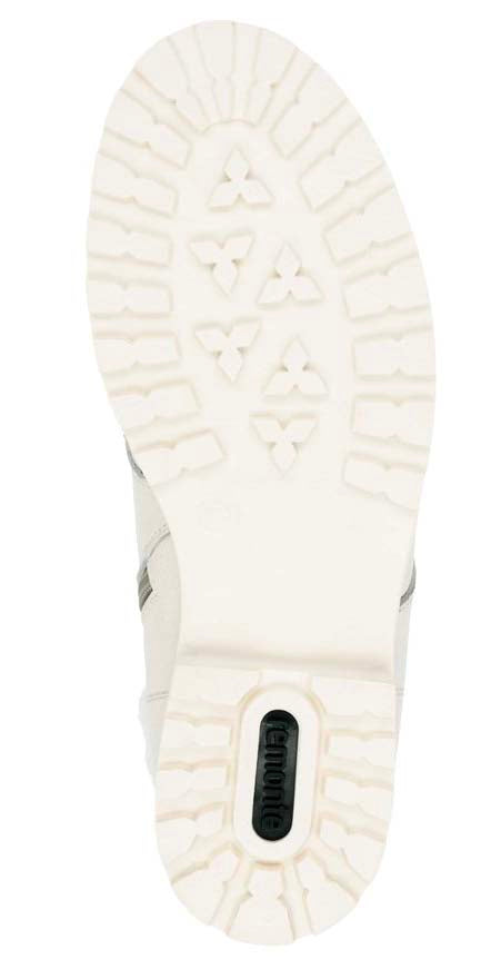 White lug sole of a shoe with a green oval detail.