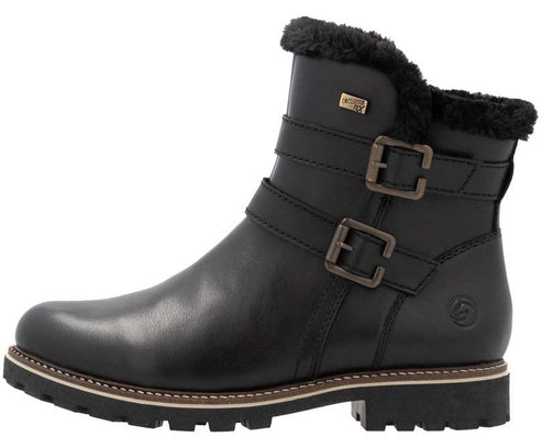 Black ankle boot with two straps and buckles, faux fur trim, and lug sole.