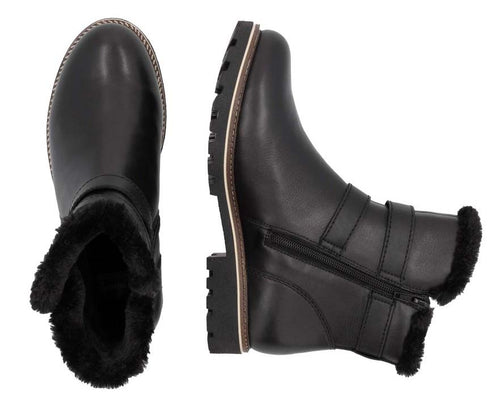 Two black leather ankle boots, one upright and one on its side, with faux fur trim and buckle detail.
