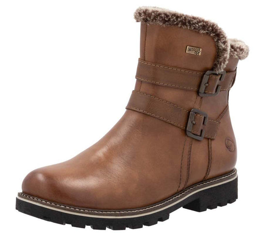 Tan ankle boot with faux fur trim and two buckle straps
