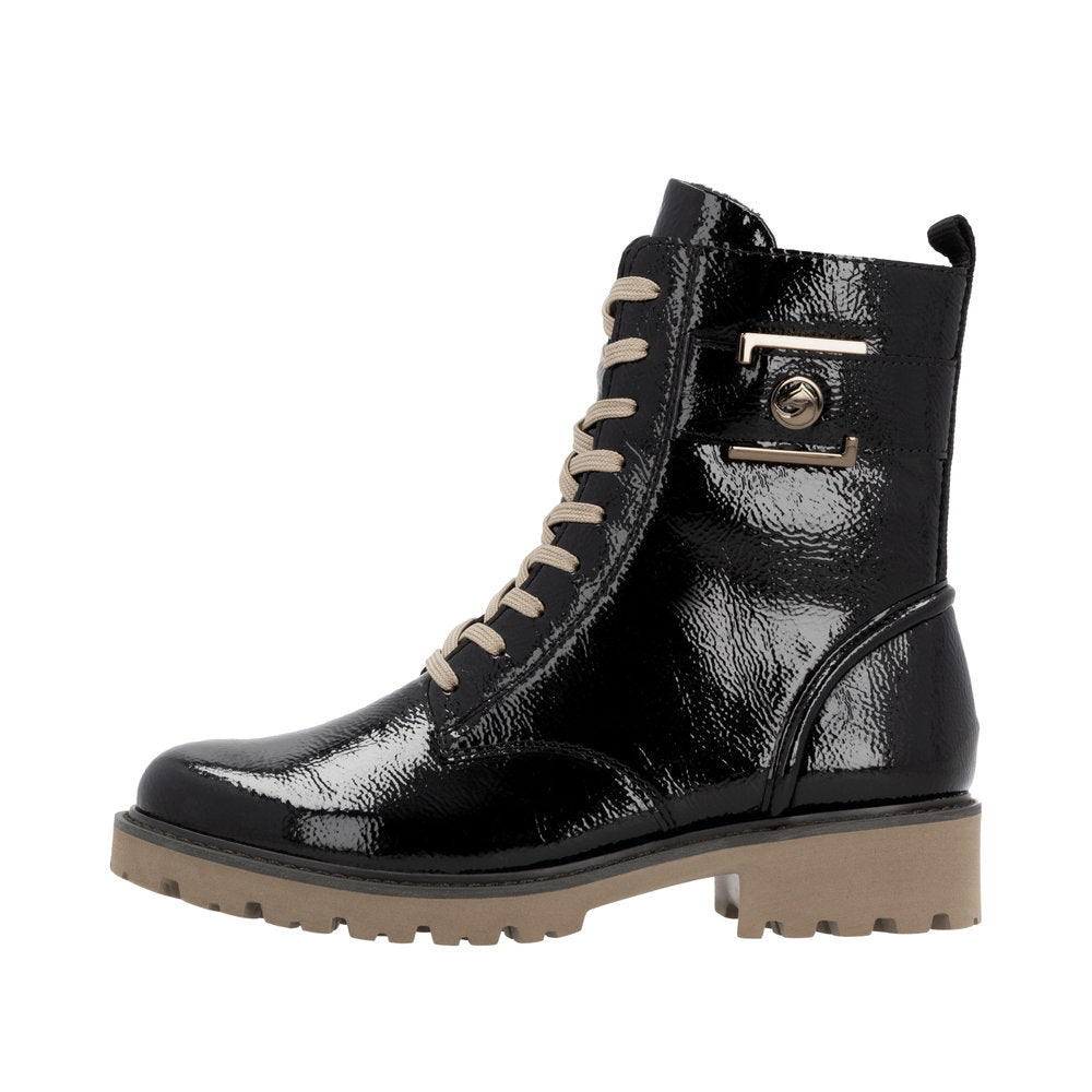 A black patent leather combat boot with beige laces and a light brown treaded sole.