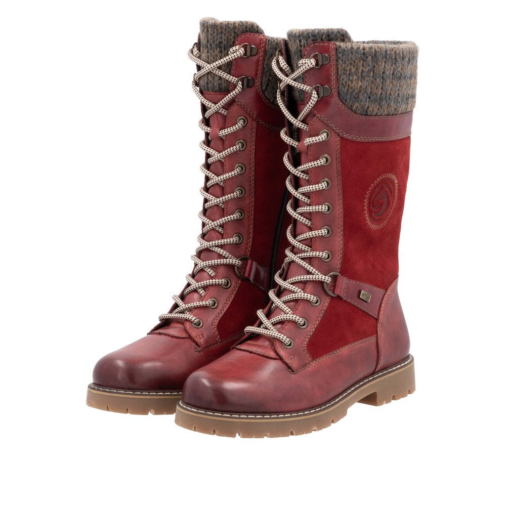 Pair of mid-calf red leather lace-up boots with ribbed knit cuff.