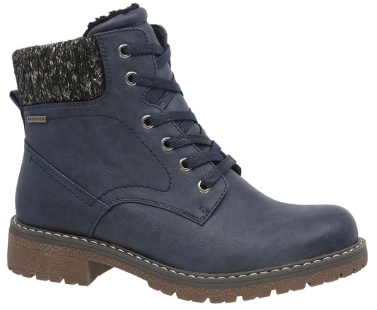 Navy blue ankle boot with a brown sole, metal eyelets, and a knitted ankle cuff