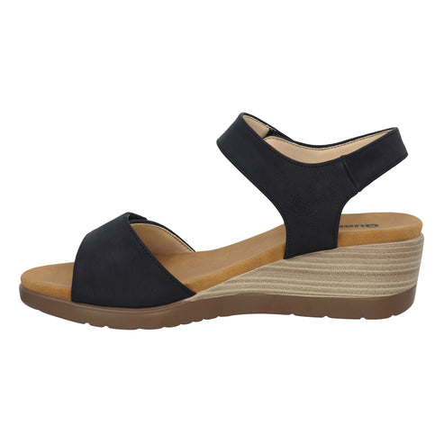 A black wedge sandal with an ankle strap and a wide strap across the toes.