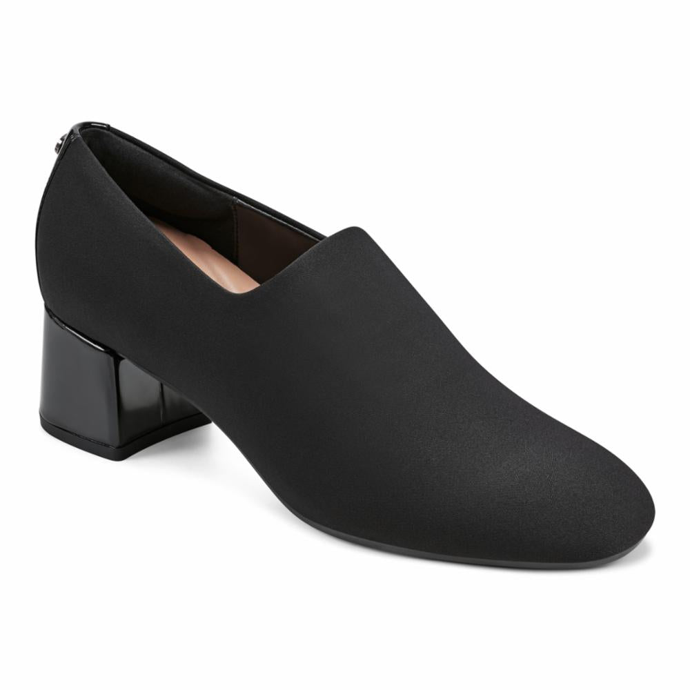 Black heeled loafer with a short, shiny block heel.