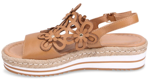 Tan platform sandal with flower cutouts and ankle strap.