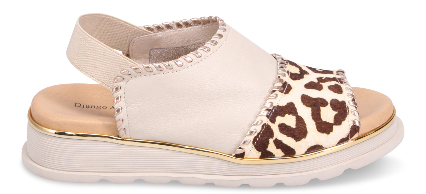 A sandal with a beige upper and a leopard print toe.