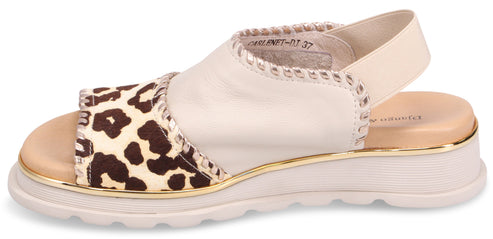 Sandals with animal print on the front and a strap.