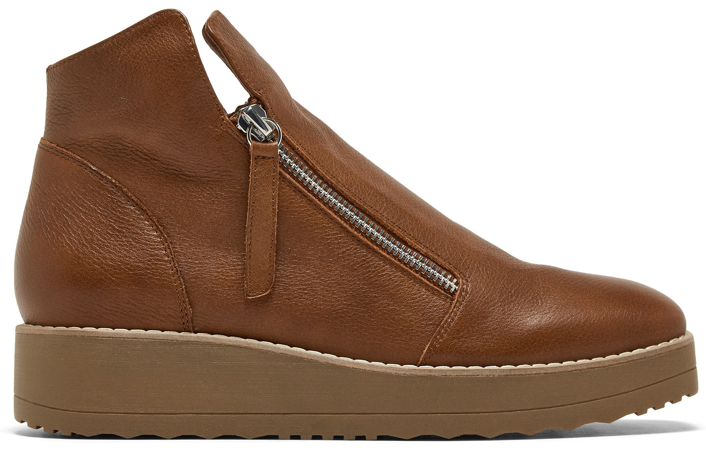 A tan leather, ankle-height flat boot with a side zipper closure and a thick, textured gum-colored platform sole.