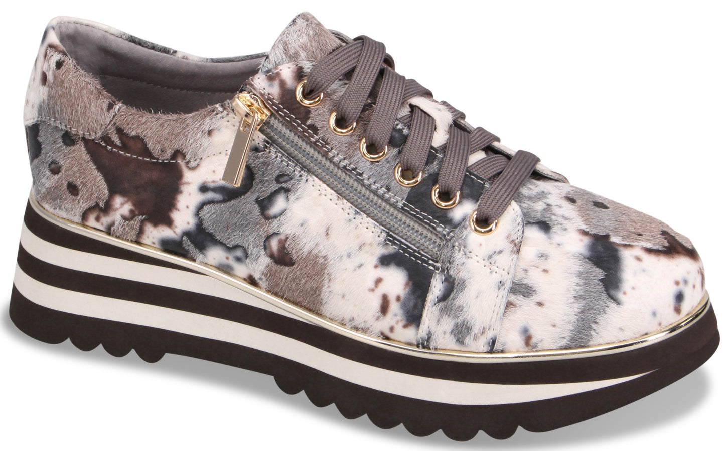 A platform sneaker featuring a multi-colored abstract animal print in shades of grey, black, and white. It has a side zipper closure, grey laces, and a thick, layered sole with a white stripe and a jagged, dark brown tread.